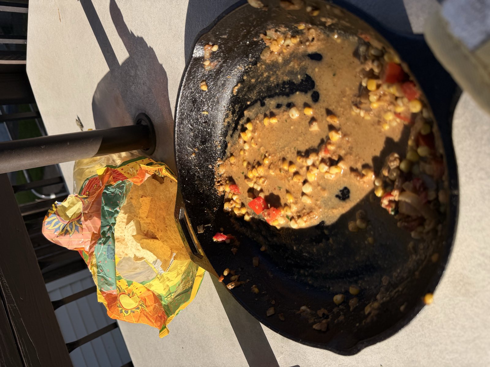 A cast-iron skillet scraped nearly clean, a few kernels of corn left in the sauce